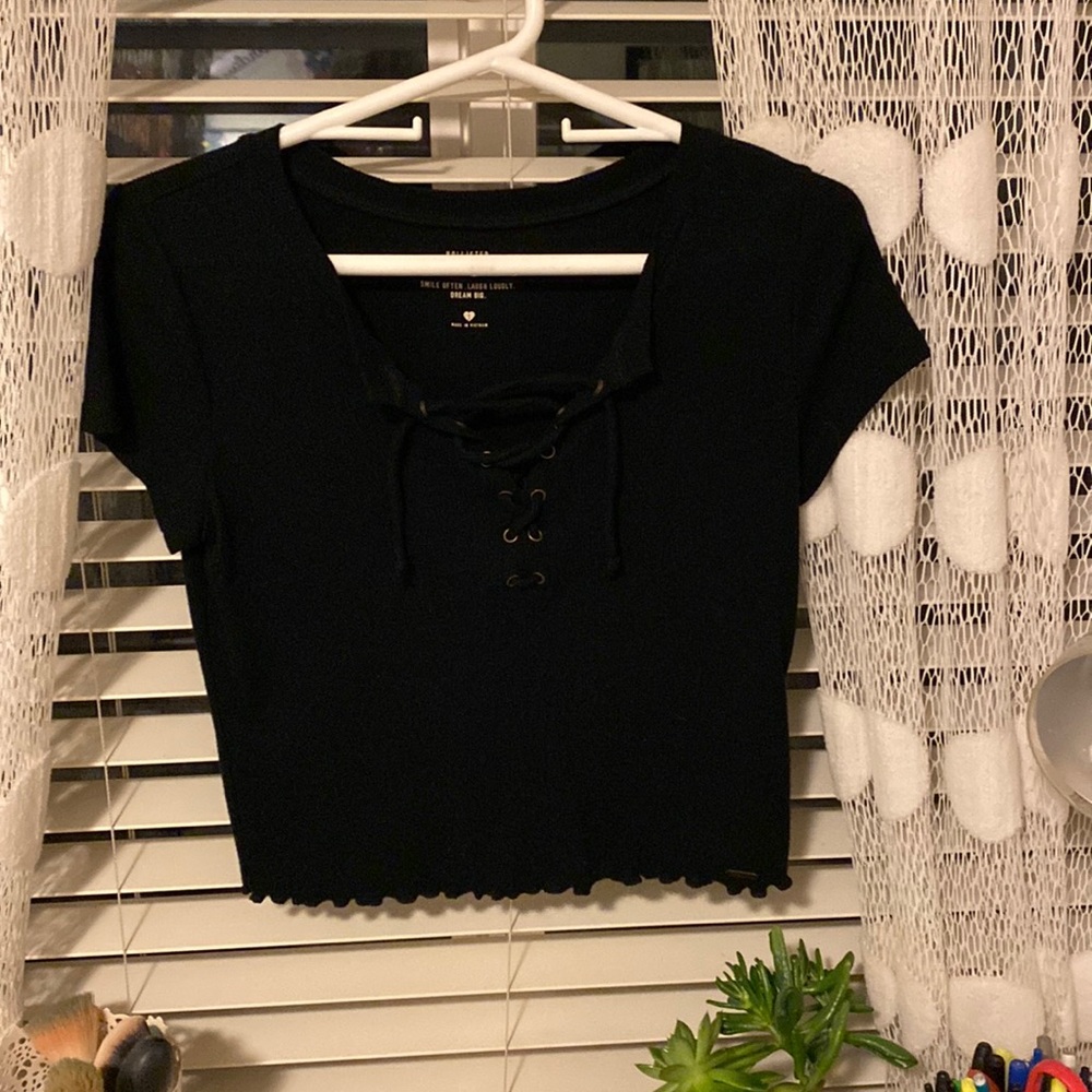 Black shirt sleeve Hollister top, lace up in the front barely worn